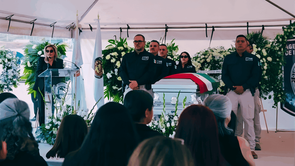 Ceremonia fúnebre de agentes fallecidos en Chihuahua con autoridades de seguridad y féretro cubierto con bandera mexicana